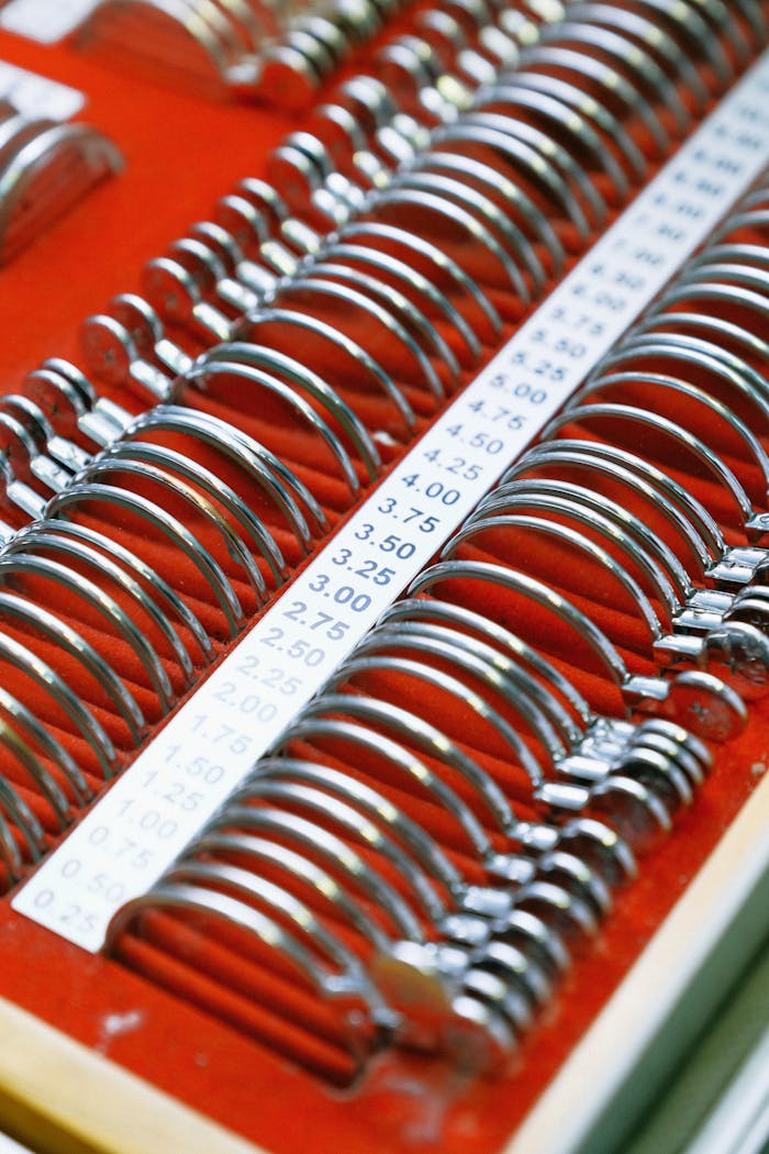 Close-up of optical lenses arranged on red surface, ideal for vision testing.